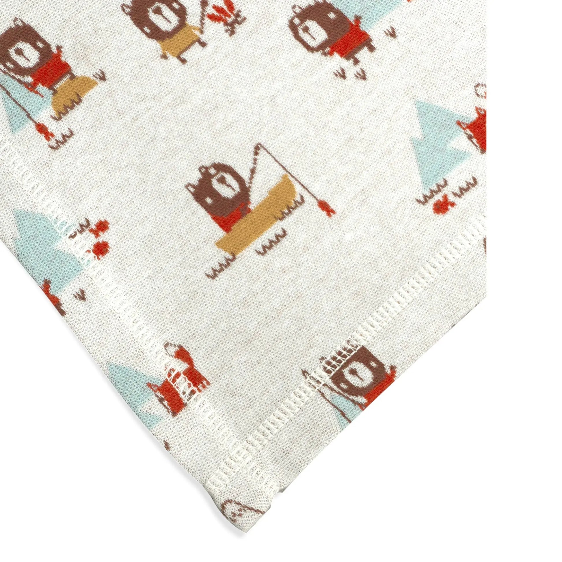 This image provides a close-up of the edge of a baby blanket, highlighting the detailed stitching and the playful camping-themed print. The design includes adorable bears and foxes engaging in outdoor activities like fishing, with soft pastel trees and mountains in the background. The neat stitching around the border adds durability and a finished look to the blanket, making it both functional and charming.