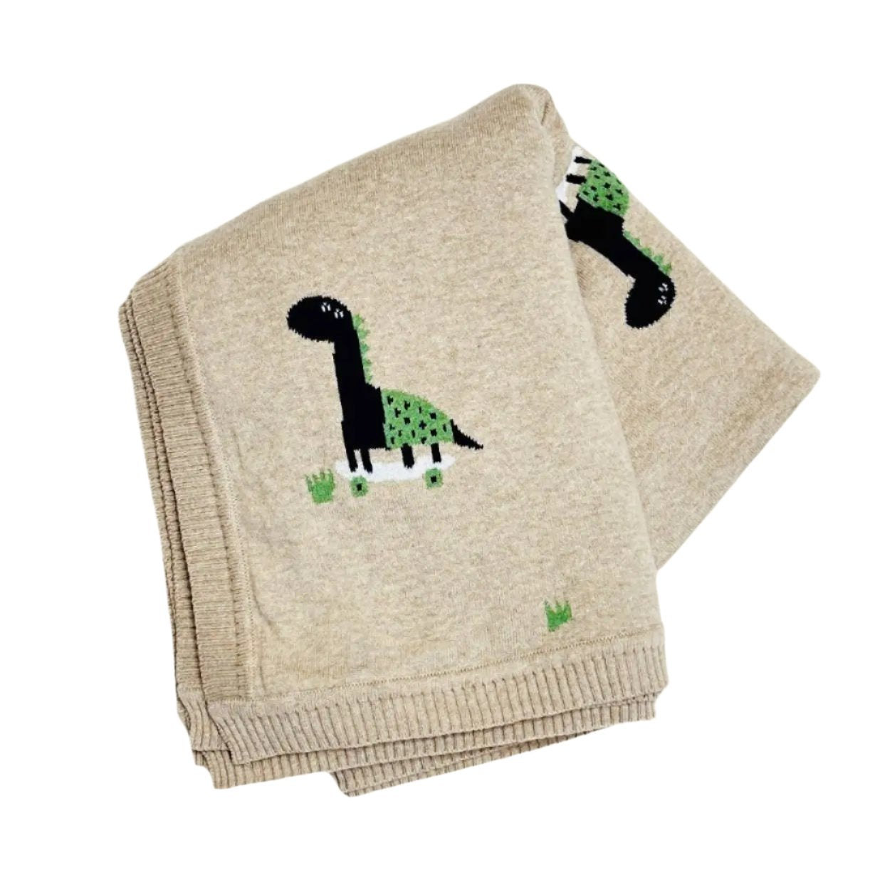 This image shows a folded baby blanket made from organic cotton, featuring a playful design of a dinosaur riding a skateboard. The dinosaur is black and green with spots, adding a fun and whimsical touch to the beige background. The blanket's ribbed edges give it a finished, cozy look, making it both a practical and charming accessory for any baby. The skater dino theme adds a creative, modern twist to a classic nursery item.