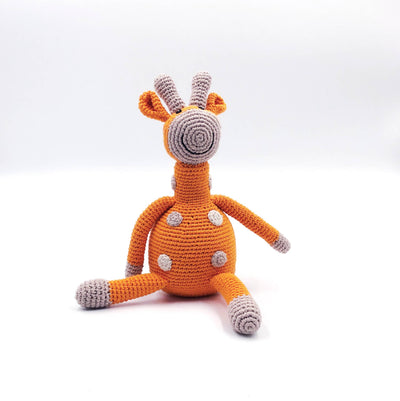 Crocheted toy giraffe on a white background