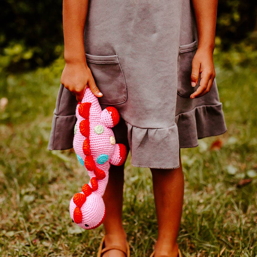 Pebble Handmade Stegosaurus Baby Rattle | Organic Cotton | Pink