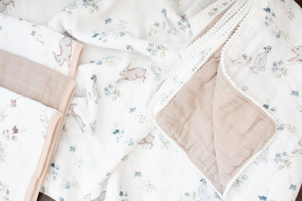 Floral-patterned baby blanket with beige border