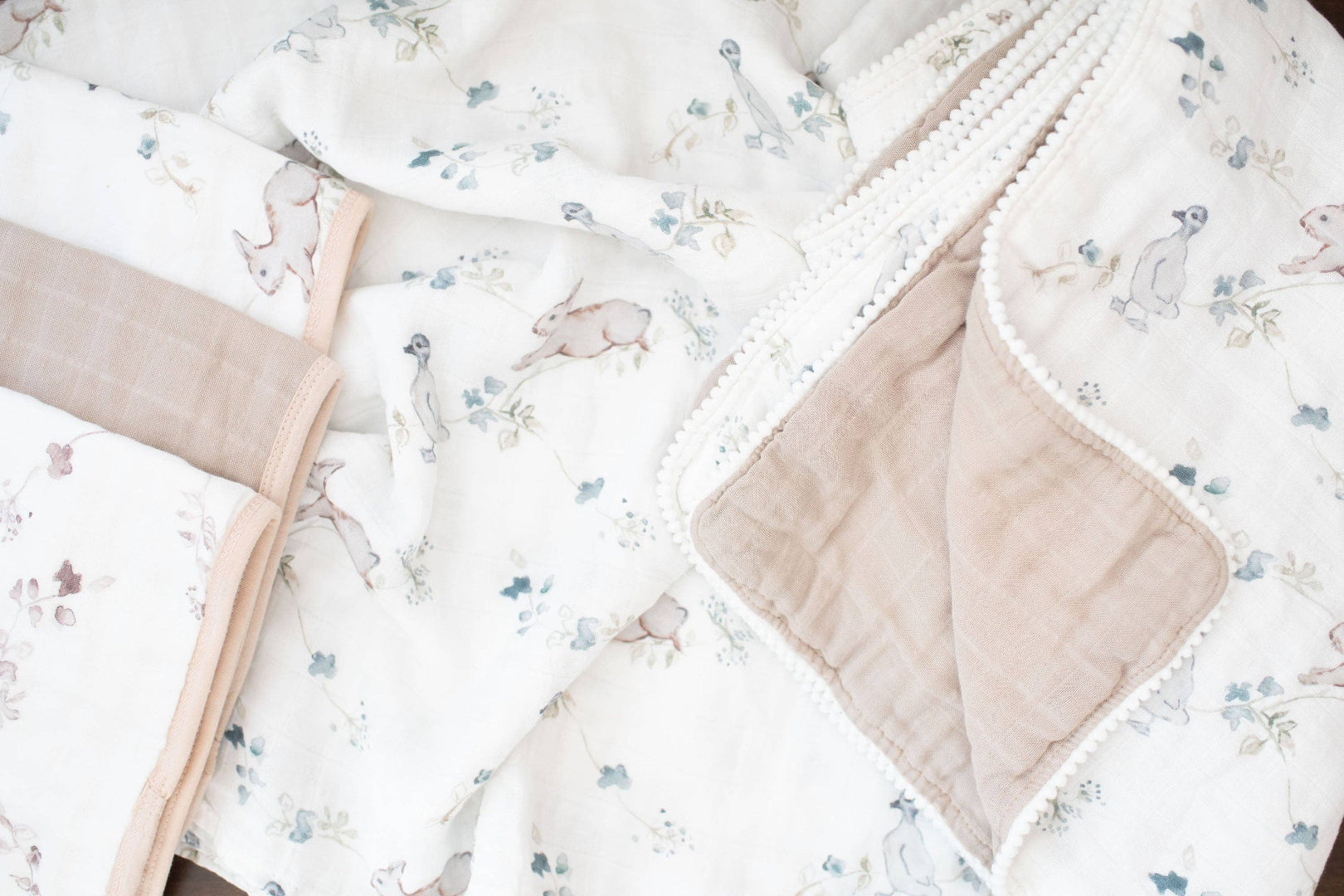 Floral-patterned baby blanket with beige border