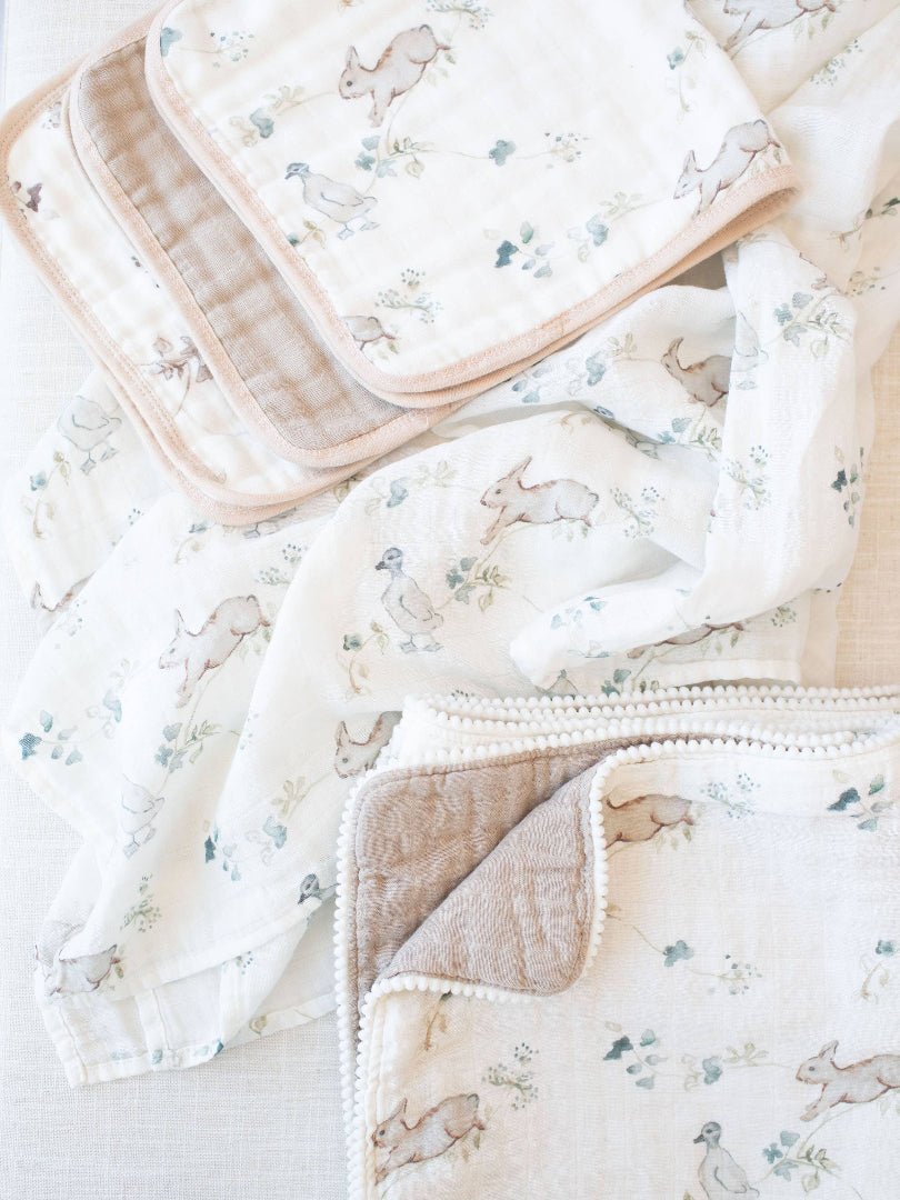 Set of baby blankets with animal prints on a light background