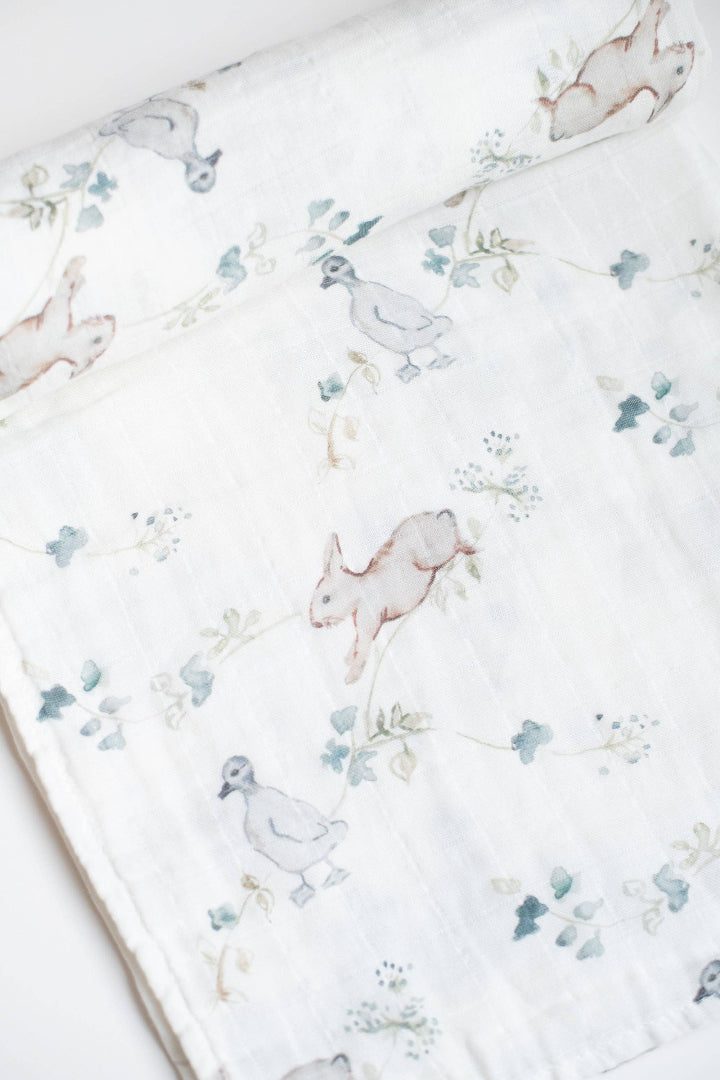 Floral patterned fabric with animal illustrations on a white background