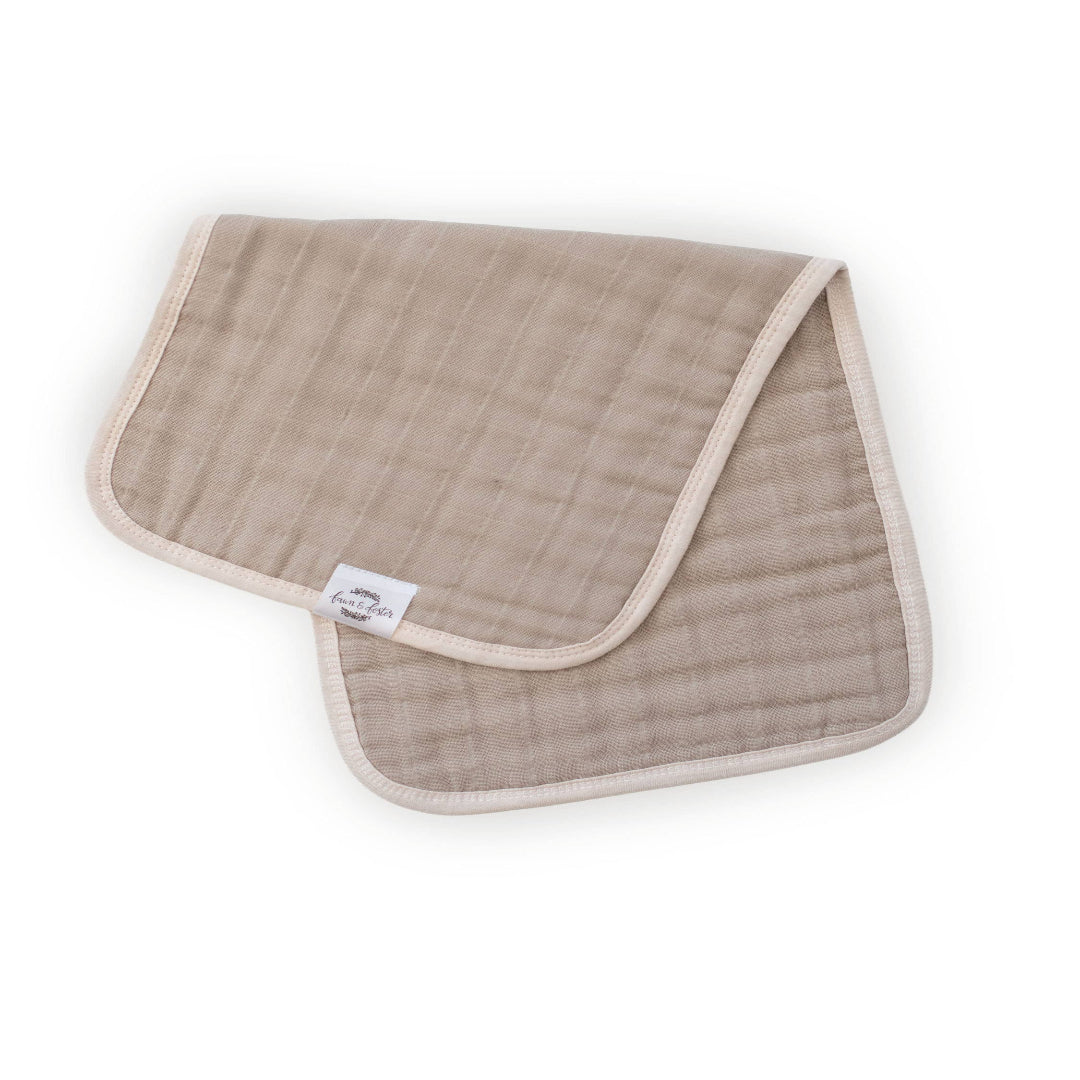 Brown baby blanket with a white label on a white background