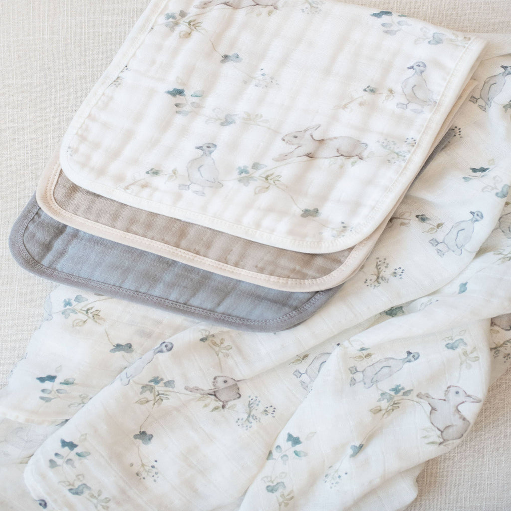 Set of baby blankets with animal prints on a light background