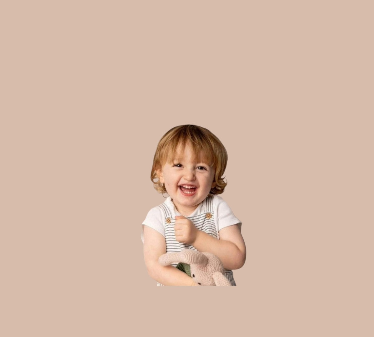 A toddler holding a stuffed animal bunny rabbit. 